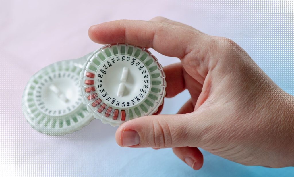 Someone holding a HRT pill capsule.