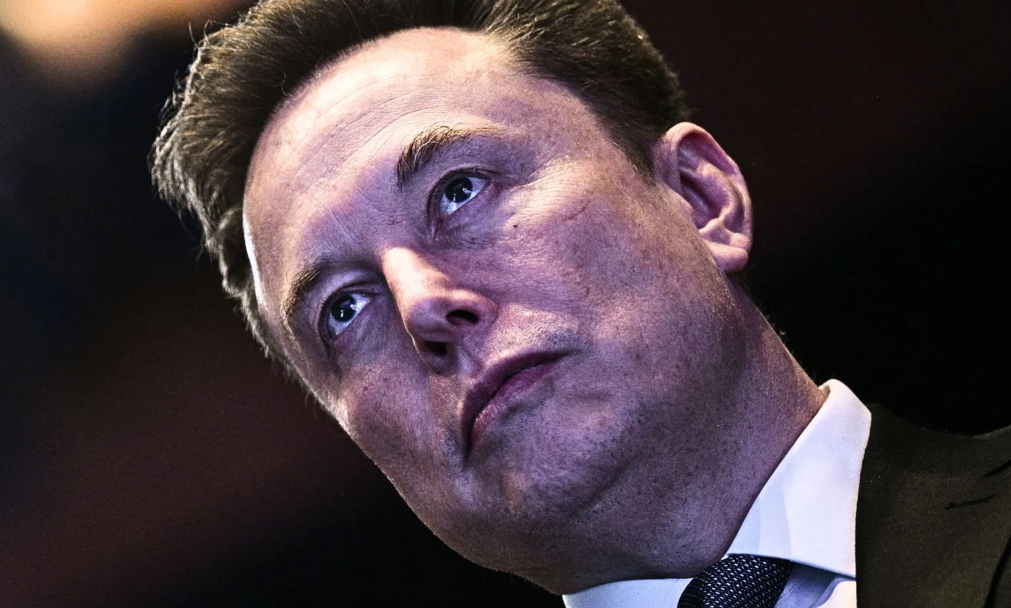 A tilted photo of Elon Musk.