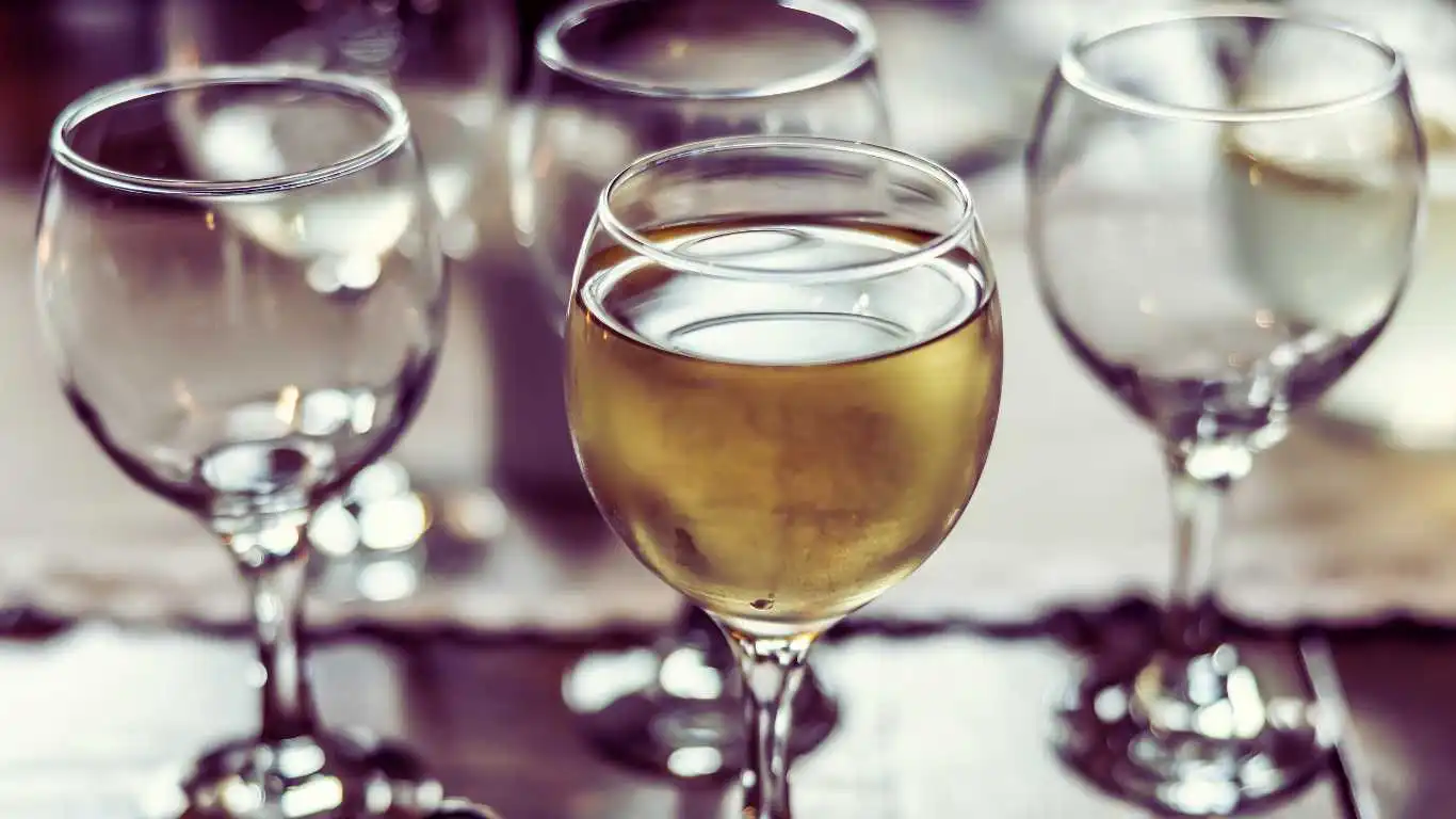 Several drunk glasses of wine and car keys next to them.