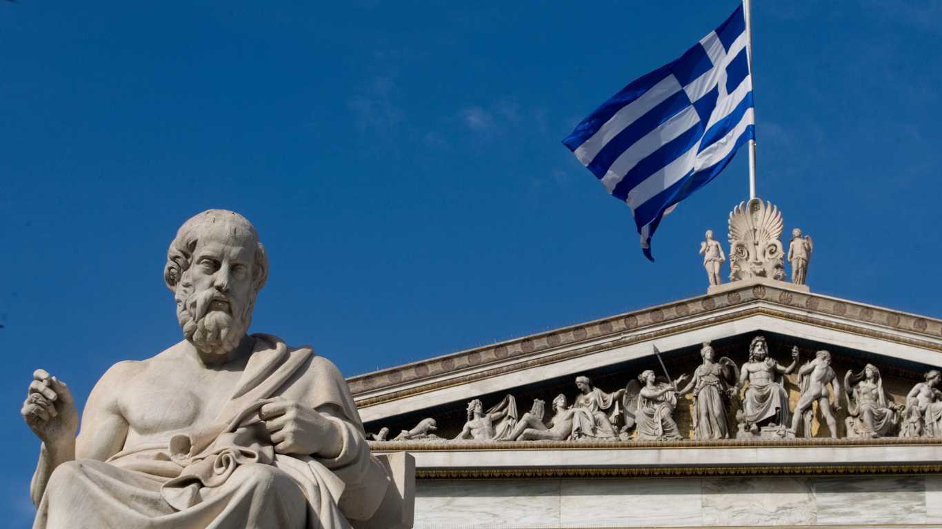 A statue of the ancient Greek philosopher Plato stands outside the Athens Academy.