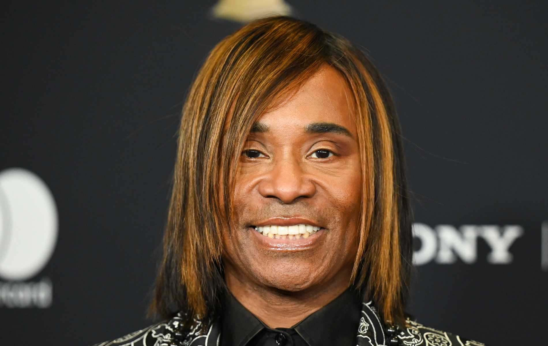 Billy Porter pictured smiling with a bob hairstyle.