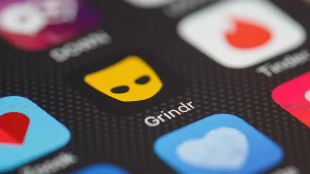 The "Grindr" app logo is seen amongst other dating apps on a mobile phone screen.