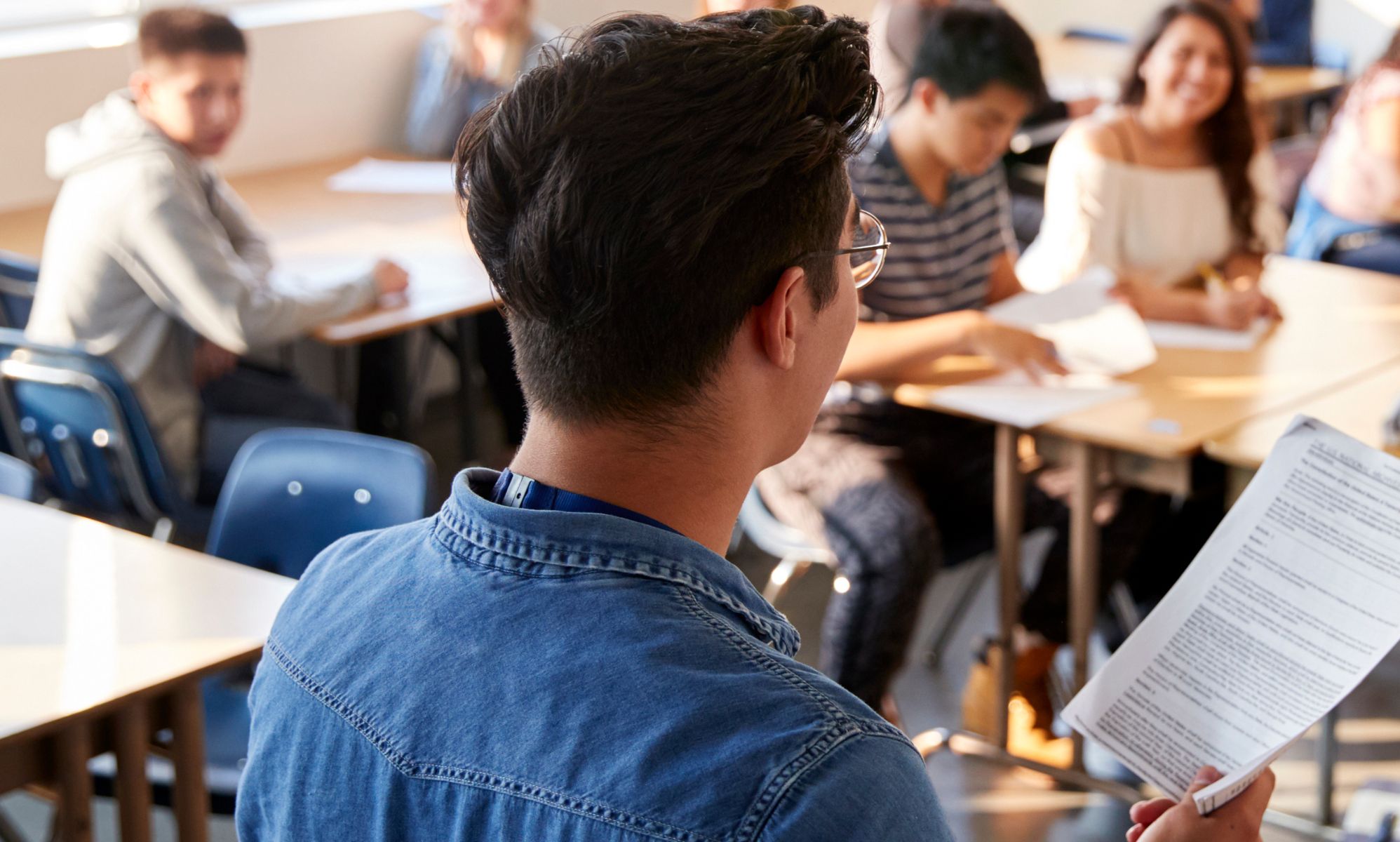 The back of a teacher at a school.