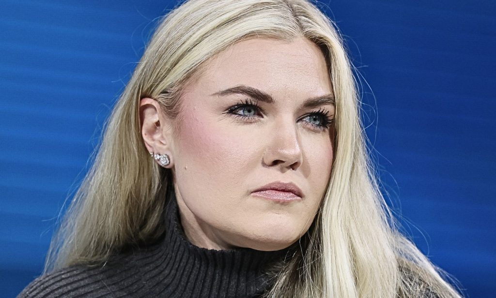 A portrait image of Erika Kirk looking off to the right.