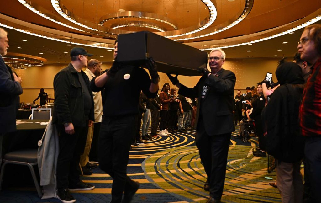 Pallbearers proceed with symbolic coffins at the Save HIV Funding Campaign