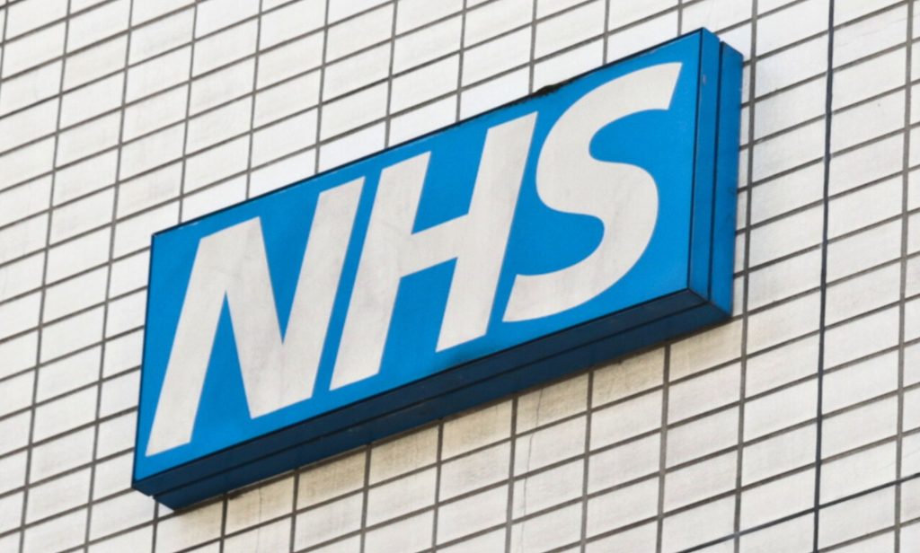 A skewed shot of an NHS sign.