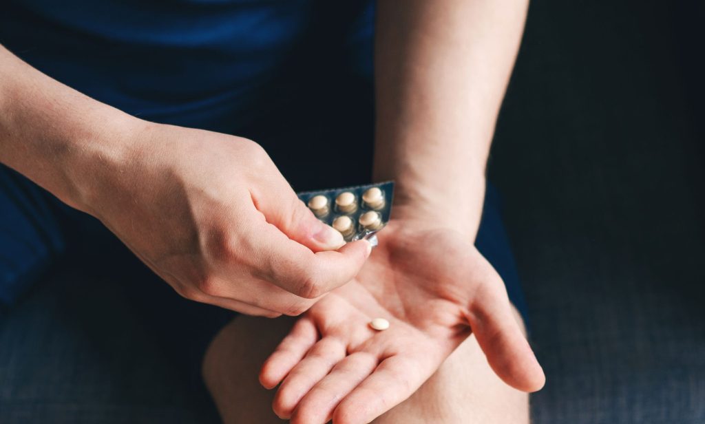 A person using a packet of hormones.