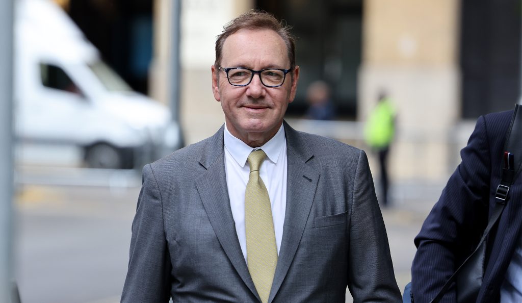 Actor Kevin Spacey arrives at Southwark Crown Court on June 30, 2023 wearing a grey suit and yellow tie