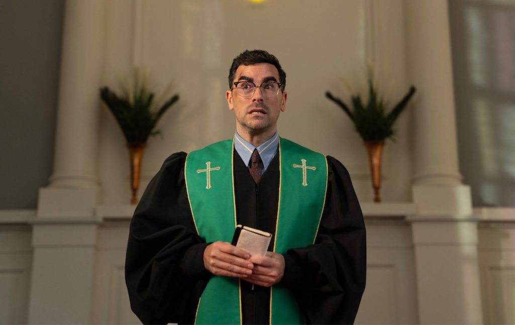 Big Mistakes Dan Levy as pastor Nicky, preaching in a churce