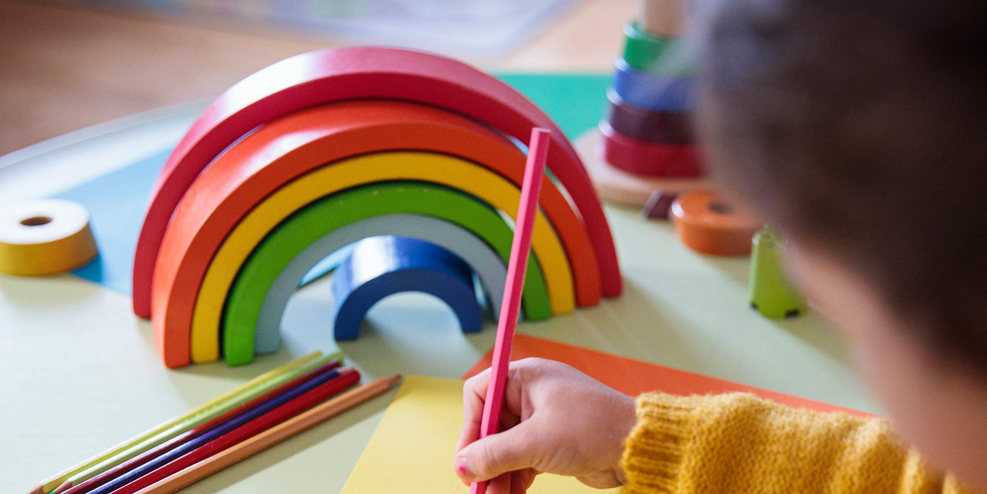 Preschooler with a rainbow toy