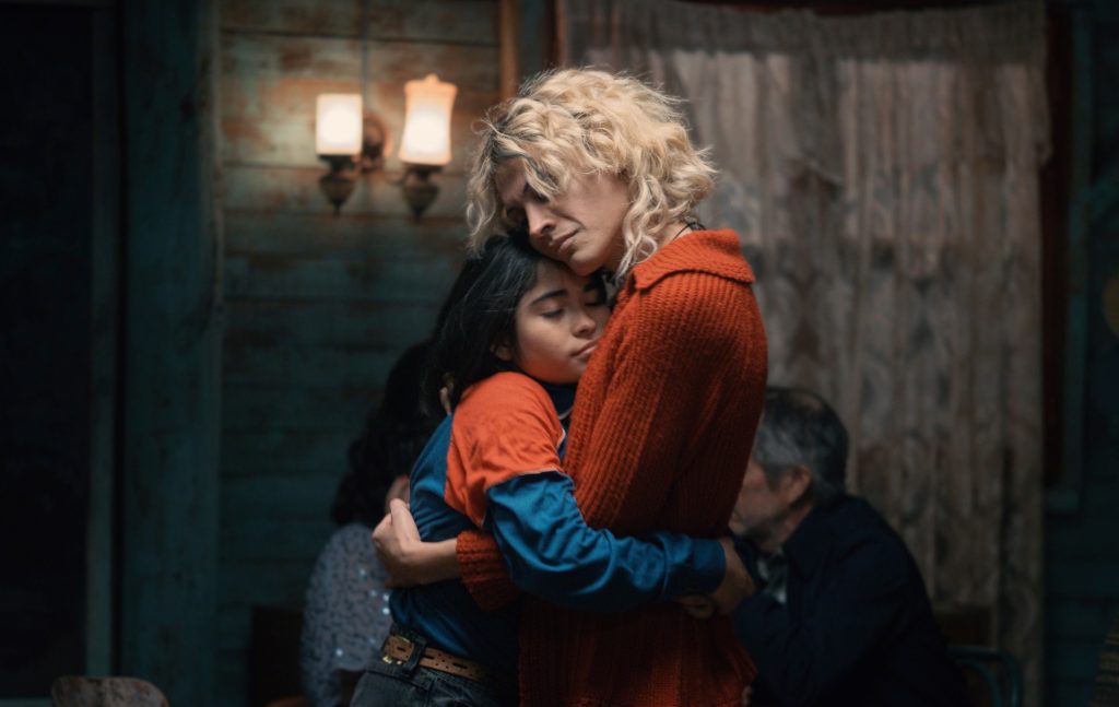 The Mysterious Gaze of the Flamingo still: a child hugging an adult