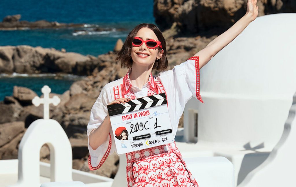 Emily in Paris star Lily Collins posing in Greece with a filming clapper board