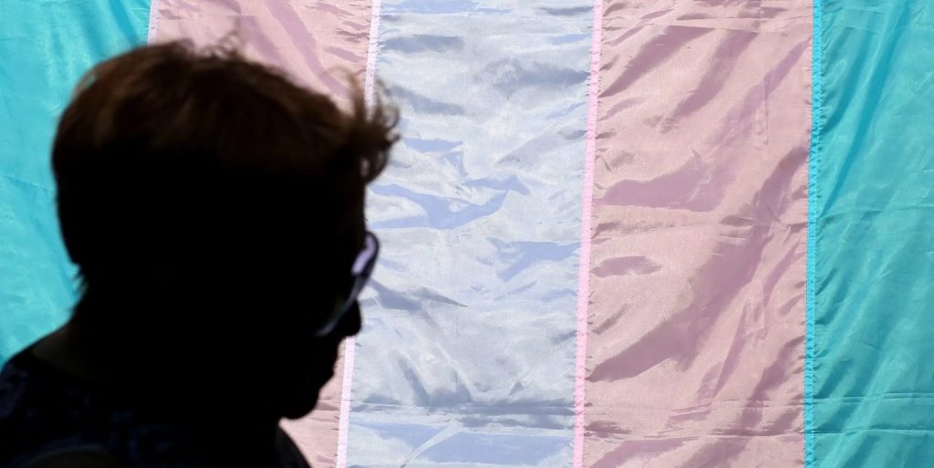 person with trans flag