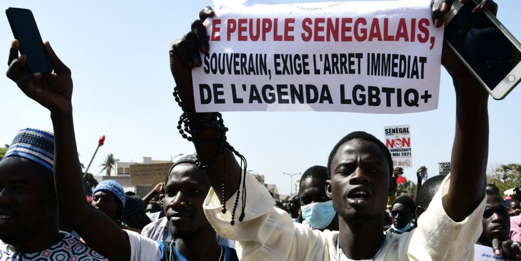 A man holds a sign reading