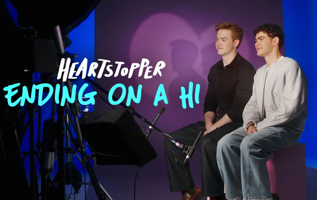 Heartstopper: Ending on a Hi still: Kit Connor and Joe Locke sat on set